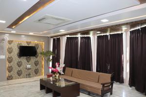 a living room with a couch and a table at Hotel Ajmer Tower in Ajmer