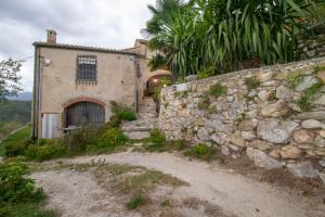een stenen gebouw met een poort en een stenen muur bij Casa dei Templari in Finale Ligure