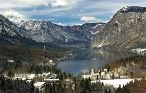 a lake in the middle of a snowy mountain at Apartmaji Gorenc in Bohinj