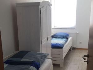 a bedroom with two beds and a window at Ferienwohnung Orthsee in Hohen Wangelin