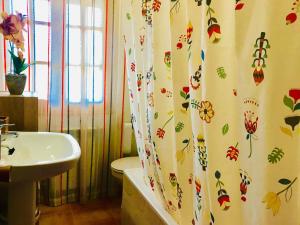 a bathroom with a sink and a shower curtain at Casa Rural Los Acebos in Riópar
