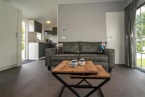 a living room with a couch and a table at Camping De Strandloper in Scharendijke