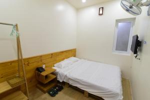 a hospital room with a bed and a window at Gấu's House in Vung Tau