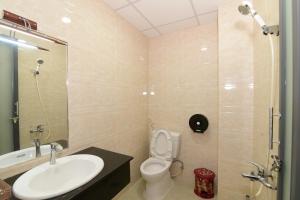 a bathroom with a sink and a toilet and a shower at Gấu's House in Vung Tau