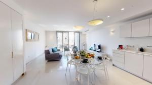 a kitchen and living room with a table and chairs at Rental Israel-Mamila Residences 14 in Jerusalem