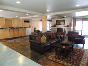 a living room with a leather couch and a kitchen at Park Regency in Park City