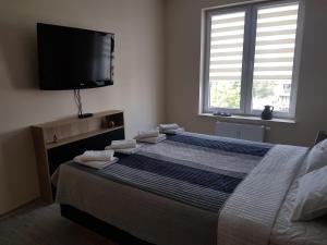 Łóżko lub łóżka w pokoju w obiekcie Apartament Bałtyk Polanki Park, basen, sauna, fitness, sala zabaw dla dzieci