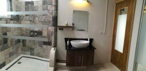 a bathroom with a sink and a shower at Le Morne Kite Villas - Penthouse in La Gaulette +17 photos
