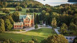 an aerial view of a mansion with trees and a park at Torreby Slott Hotel & Golf in Munkedal