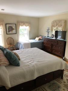 a bedroom with two beds and a dresser at Aiken Manor B&B in Franklin