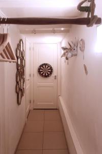 a hallway with a white door with a dartboard on the wall at Cozy Canal Studio in Amsterdam