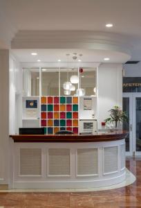 a kitchen with a counter with a colorful tile wall at Santiago Apartments Bilbao in Bilbao