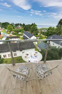 a patio with a table and two chairs on a balcony at Król Plaza Spa & Wellness in Jarosławiec