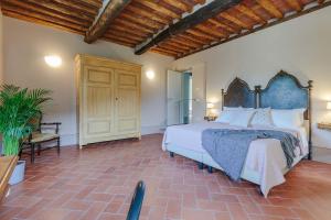 a bedroom with a large bed and a wooden ceiling at Antica Pergola di San Giusto in Capannori +41 photos