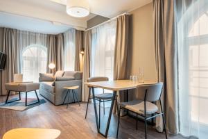 a living room filled with furniture and a table at Aparthotel Adagio Lille Centre Grand Place in Lille