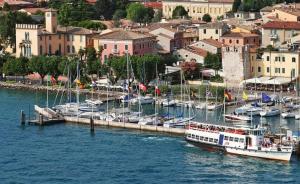 a group of boats docked at a dock in a harbor at Hotel Alla Riviera in Bardolino