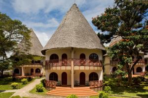 a large building with a thatched roof at Neptune Paradise Beach Resort & Spa - All Inclusive in Galu