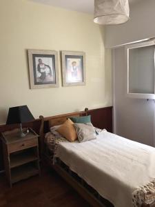 a bedroom with a bed and a table with a lamp at AMPLIO DEPARTAMENTO EN SANTA ROSA in Santa Rosa