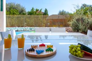 a table with a plate of fruit on top of it at Galini Villas in Mikros Gialos