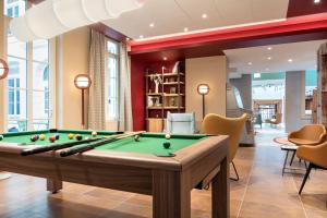 a living room filled with furniture and a pool at Aparthotel Adagio Lille Centre Grand Place in Lille