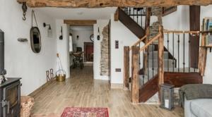 a living room with wooden floors and a staircase at Rosie's Barn in Penrith