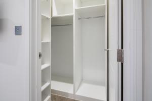 a walk in closet with a glass door at Hausd - Leicester Square in London +133 photos
