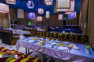 a dining room with tables and plates of food at Hotel Buston in Chkalovsk