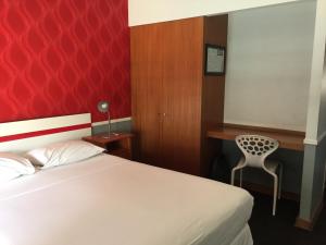Säng eller sängar i ett rum på GUANAKO Hostel