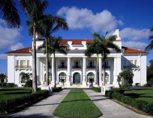 a white house with palm trees in front of it at Casa Azul Lagoon With Private Pool! Home in West Palm Beach