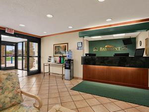 a restaurant lobby with a bar with a cash register at Baymont by Wyndham Sullivan in Sullivan