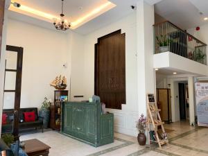 a living room with a staircase and a green door at Elliebum Boutique Hotel in Chiang Mai
