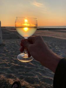 a person holding a candle in a wine glass on the beach at Ferienwohnung Bunte Kuh Wangerooge in Wangerooge +38 photos