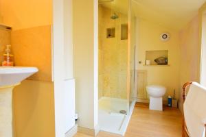 a bathroom with a glass shower and a toilet at 7 Monk Bar Court YORK in York +8 photos