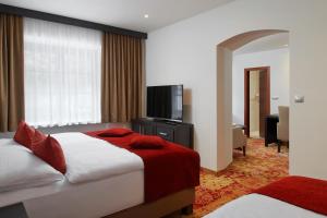 Posteľ alebo postele v izbe v ubytovaní Hotel Singer