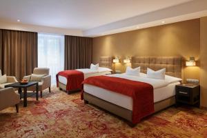 Posteľ alebo postele v izbe v ubytovaní Hotel Singer