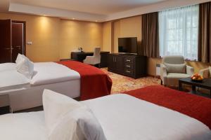 Posteľ alebo postele v izbe v ubytovaní Hotel Singer