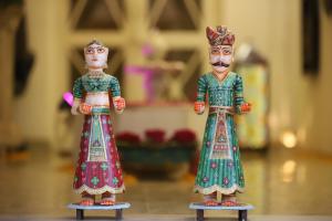 two toy dolls are standing next to each other at The Kothi Heritage in Jodhpur