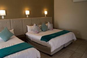 Säng eller sängar i ett rum på Crystal Rose Lodge & Spa