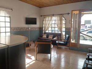 a living room with a couch and a table at Hotel Alonso in Río Gallegos