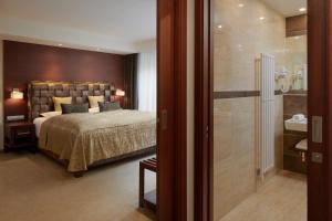 Posteľ alebo postele v izbe v ubytovaní Hotel Singer