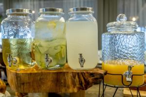 three jars of lemonade on a wooden table at Hotel Cardoso in Maputo