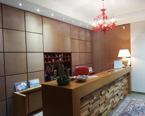 a reception desk with a red chair in a room at Giga Hotel in Villa Santa Lucia
