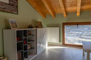 a living room with a book shelf and a window at VISTAS AL VALLE SALADO in Salinas de Añana