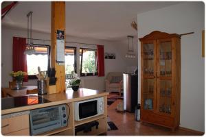 a kitchen with a counter top and a microwave at Apartment Edersee für 4 Personen in Frankenau