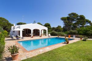 a swimming pool in the yard of a house at Casa con jardín y piscina - MORELL ONZE in Cala Morell