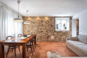 a living room with a table and a couch at Can Terrats in Blanes