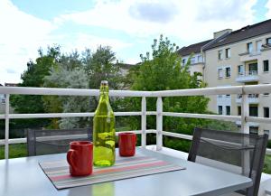 een fles wijn op een tafel op een balkon bij Little Suite Clarisse in Marcq-en-Baroeul