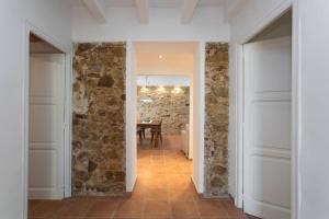 a hallway with a stone wall and a table at Can Terrats in Blanes