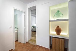 a hallway with a vase on a shelf next to a door at Can Terrats in Blanes