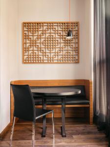 a black table and a black chair in a room at Hotel Balmes, a member of Preferred Hotels & Resorts in Barcelona